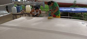 Akoosh and Chambron polishing the top of the bimini