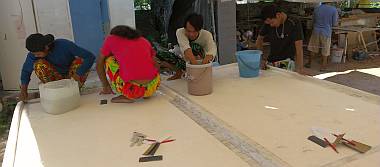 Ben and our brightly dressed Indonesians polishing the bimini