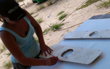 Amanda cutting "future board" to fill access holes in our targa-bar