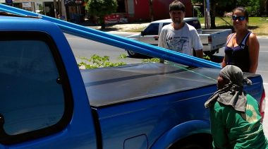 Tying the PVC pipe to Golf's truck