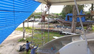 Jon climbing to the rafters so he can set (blue) sail