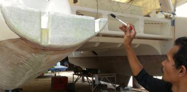 Baw touching up his newly sanded port transom