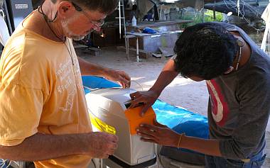 Test fitting the bright orange foam bumper on the engine