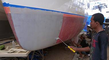 Painting primer on the port hull to finish the priming job