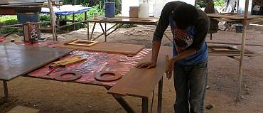 Baw sanding the edges of our floorboards