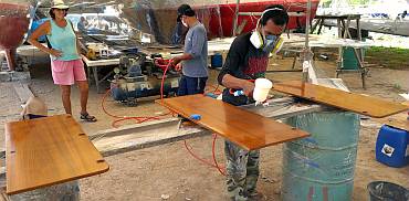 Spraying the first coat of satin varnish on some cabinet doors