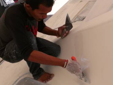 Baw, our Master Artist, touching up parts of the foredeck
