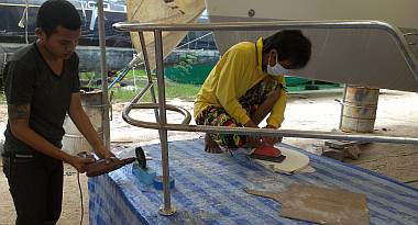 Ben polishing the pulpit while Yando sands the pulpit seat