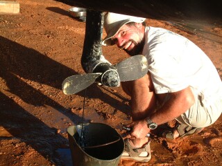 Jon draining the old oil from the Sail-drives.  The oil gets recycled.