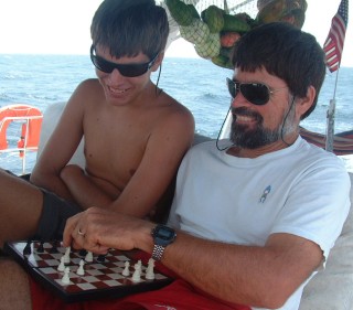 Jon and Chris enjoy a game of chess while underway