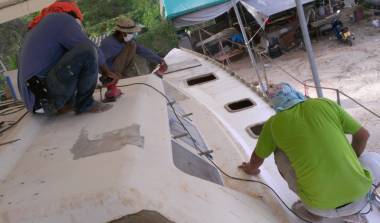 Sanding the filler smooth on Ocelot's starboard side