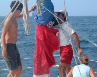 Chris, Jon, and Amanda ready the spinnaker