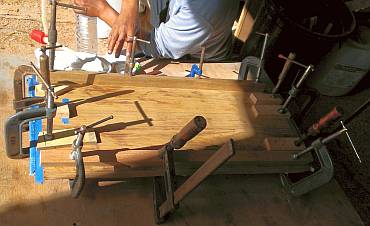 New veneer being epoxied onto the curved door