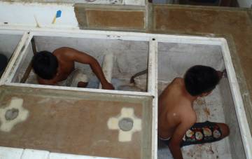 Kao and Jeng cleaning the lockers under the cockpit