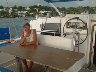 Sue in the cockpit with the seat folded back & the table open.