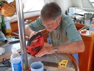 Jon's father cutting the new top-opening door for the fridge