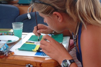 Amanda painting the Dominica flag to fly on Ocelot