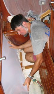 Jon fits a new formica panel in our cabin after Sue removed the old liner.