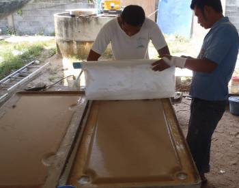 Golf & Boy glassing the newly foamed hatch covers