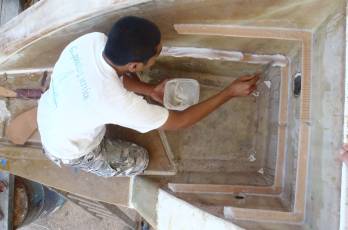 Golf spreading epoxy mud on the lower step