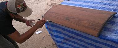 Heru putting another coat of epoxy on the curved locker door