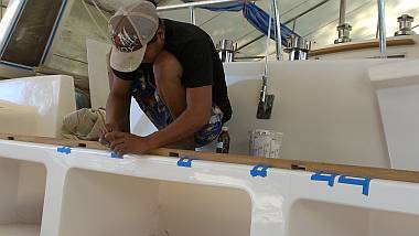 Heru repairing the gelcoat where yesterday's screws went in