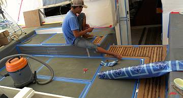 Heru covering the cockpit in vinyl to protect it