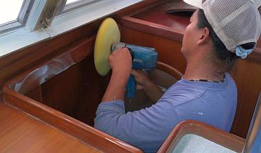 Heru polishing the new gloss polyurethane trim in the salon