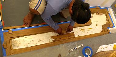 Houa gluing down a teak frame for the port side of the cockpit