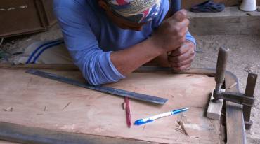 Chiseling edges of the teak laminate frame before epoxy sealing