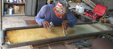 Houa sealing the routered inside of the cockpit table with epoxy