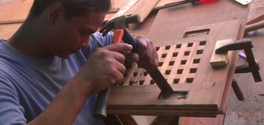Houa cutting out damaged screw-holes from his teak lattice