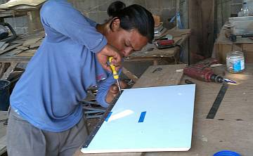 Houa screwing a piano hinge on the new head locker doors