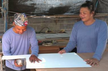 Houa and K working on a piece of formica for Amanda's cabin