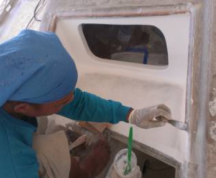 Houa smearing epoxy mud on the ridge for the shelf