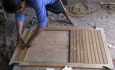 Houa filling his teak frame for a cockpit hatch with teak strips