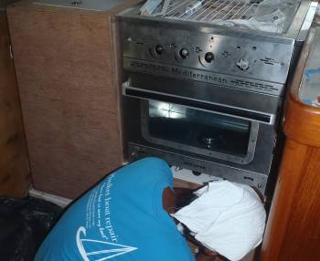 Houa, checking the fit of our new stove and oven