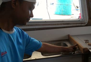 Houa trying out the placement of some teak trim in the galley