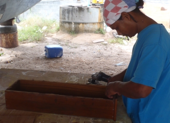 Houa in his "workshop" repairing a drawer for us