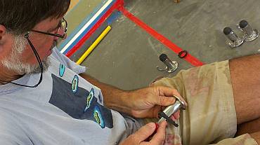 Jon whittling some new rubber bumpers door-stops