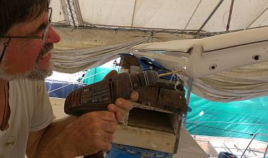 De-coring the port side of the bimini, where the leg bolts will go