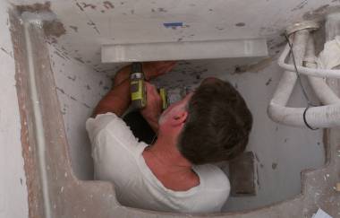 Fitting the washing machine shelf in the port fo'c's'le