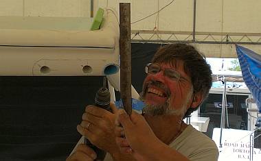 Sue helped Jon aim the drill between the ruler & the green block