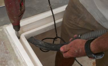 Jon drilling out a drain hole in a cockpit locker gutter