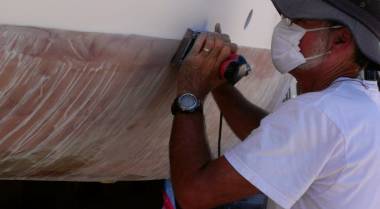 Jon sanding down the gelcoat lip at the waterline