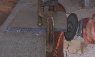 Jon grinding the edges of the rough-cut stainless steel plates