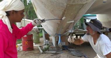 Rolling the epoxy into the 2 glass strips under the port hull