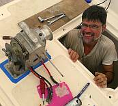 Jon emerging from a chain locker after mounting the anchor winch.