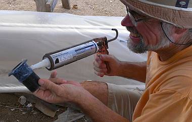 Gooping marine silicone on a through-hull transducer housing