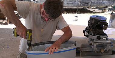 Reassembling the hardware to hold the cover on the outboard